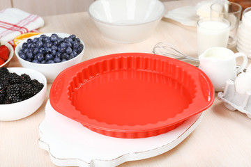 Baking tasty pie and ingredients for it on table in kitchen