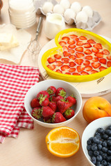 Baking tasty pie and ingredients for it on table in kitchen