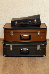 Vintage old travel suitcases on floor