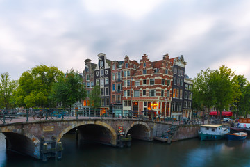 Fototapeta na wymiar Dusk city view of Amsterdam canal and bridge