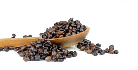 Fresh coffee beans with wooden spoon isolated over white
