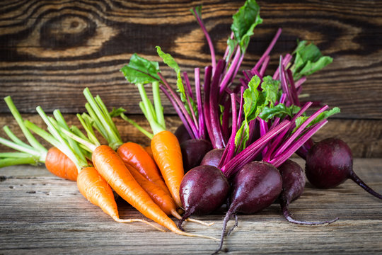 Fresh vegetables carrots, beetroots on  wooden background