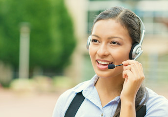 Woman customer service representative with hands free device
