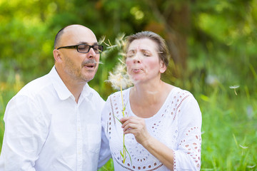 Happy mature couple enjoying weekend day in a park