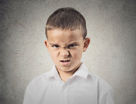 Portrait angry disgusted boy isolated on grey wall background 