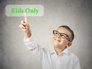 Portrait Boy Pushing Kids Only Button, grey wall background 