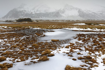 View on an Icelandic landscape with frozen tundra.