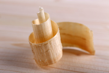 Wood shavings on wooden background closeup