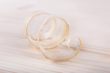 Wood shavings on wooden background closeup