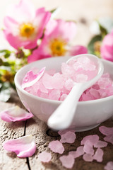 Obraz na płótnie Canvas spa with pink herbal salt and wild rose flowers