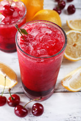 Fresh cold cherry cocktail with mint, ice and lemon