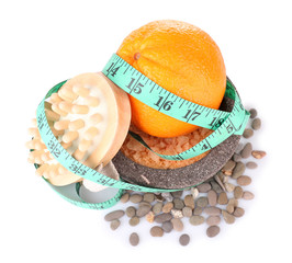 Fresh orange, tapeline, plate,bast, brush and sea stones