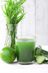Glass of fresh lime juice, lime, slices of cucumbers and vase