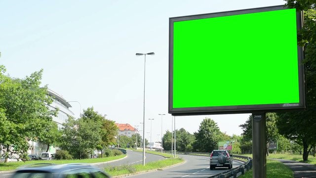 billboard - green screen - urban street with passing cars