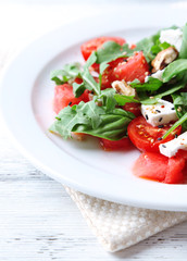 Salad with watermelon, feta, arugula and basil leaves