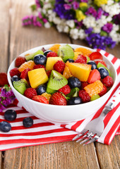 Delicious fruits salad in plate on table close-up