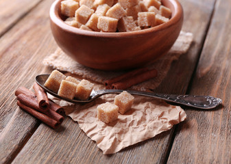 Brown sugar cubes in bowl, star anise and cinnamon sticks