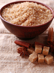 Brown sugar cubes and crystal sugar, spices in bowl