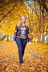 happy girl and autumn leaves