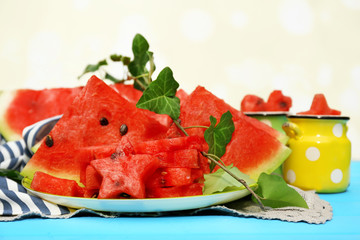 Fresh slices of watermelon on table, on bright background