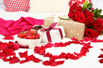 Romantic still life with strawberry, gift boxes and petals of