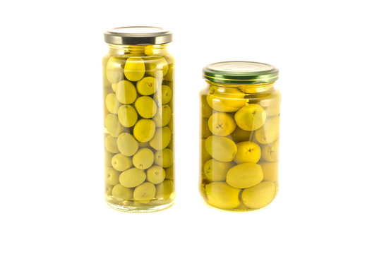 Green olives two glass jar isolated on white