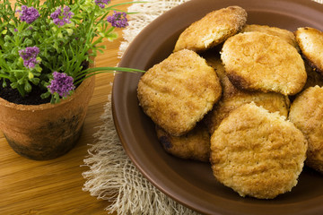Plate of cookies and flower on wood table