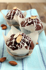 Tasty cupcakes with nuts on table close-up