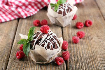 Tasty cupcakes with raspberries on table close-up