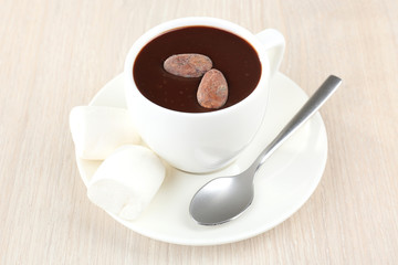 Cup of hot chocolate on table, close up