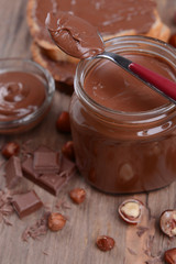 Sweet chocolate cream in jar on table close-up