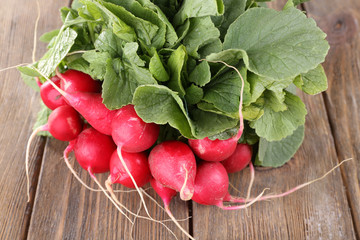 Heap of fresh radish on wooden background