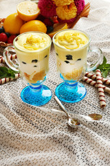 Tasty lemon desserts on table at home