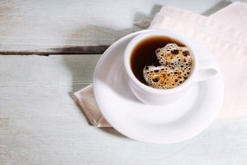 Cup of coffee on color wooden background