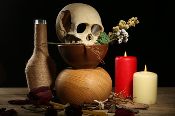 Human skull with dried rose petals and candle