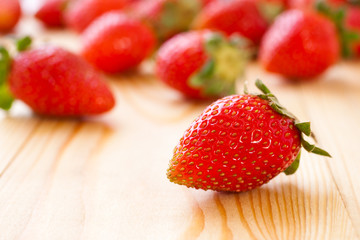 Strawberry on a wooden surface closeup