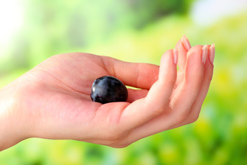 Purple grape in hand on natural background
