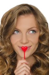 young woman holding heart in front lip