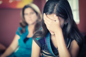 Teenage girl cries with her mother on the background - 68807138