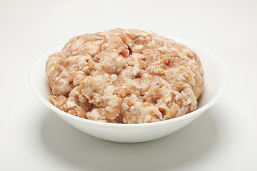 Pork mince in the bow on the bright background