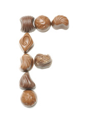 Alphabet letter F arranged from chocolate sweets isolated