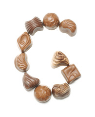 Alphabet letter G arranged from chocolate sweets isolated