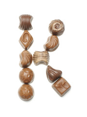 Alphabet letter K arranged from chocolate sweets isolated