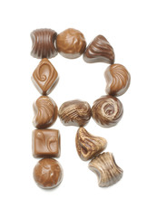 Alphabet letter R arranged from chocolate sweets isolated