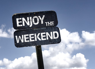 Enjoy the Weekend sign with clouds and sky background - obrazy, fototapety, plakaty