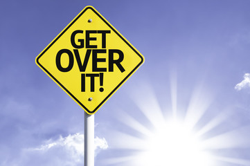 Get Over It! road sign with sun background