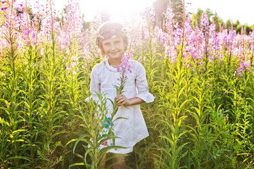 Girl playing in a field of flowers