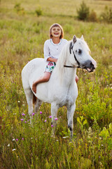 Obraz na płótnie Canvas Little girl riding a horse