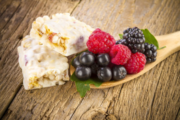 Muesli bars with fresh berries in spoon