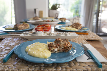 Homemade Lasagna and Mashed Potatoes in a Plate
